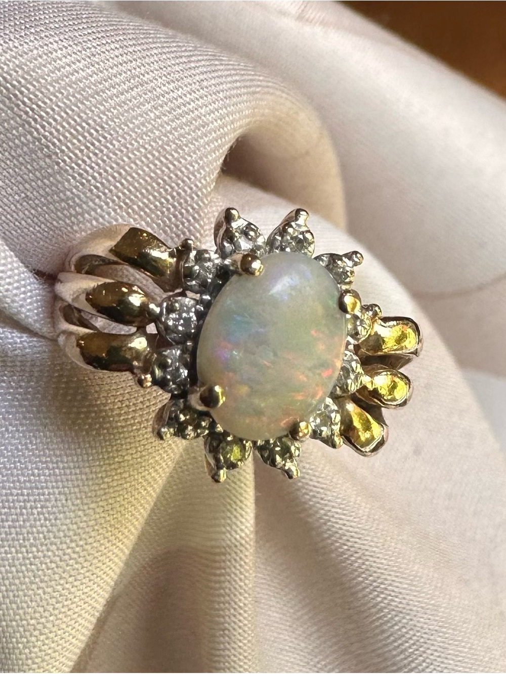 Opal and Diamond Halo Ring in 14-carat gold – White Opal Center